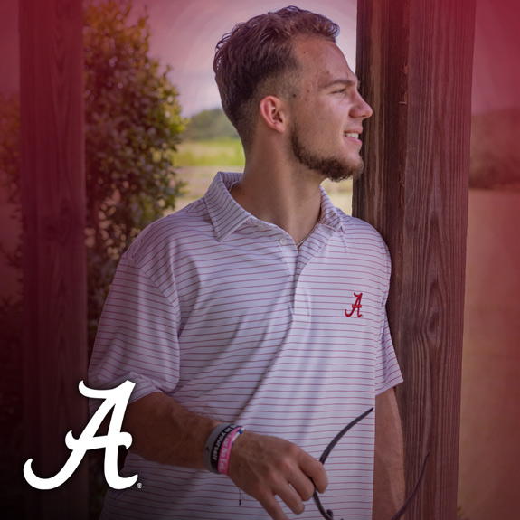 Man wearing Univeristy of Alabama white and red striped polo.