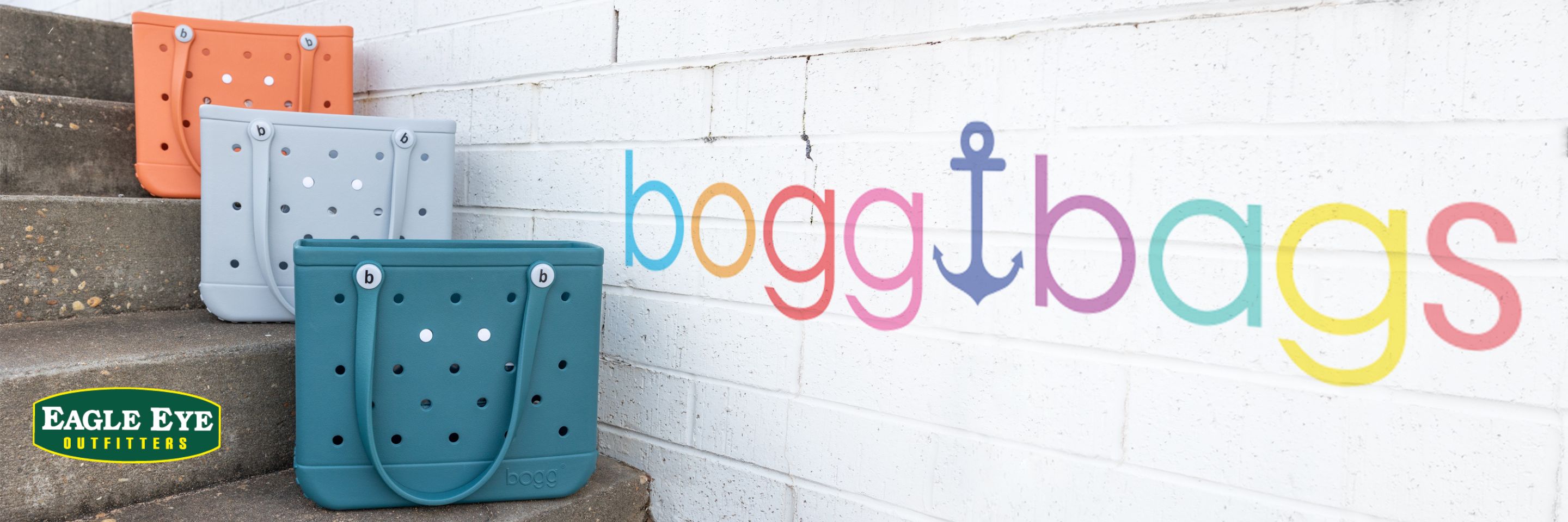 Three Baby Bogg Bags lined up on steps in Gourd, Grey and Teal.