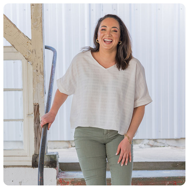 Woman laughing wearing a casual women's fashion outfit