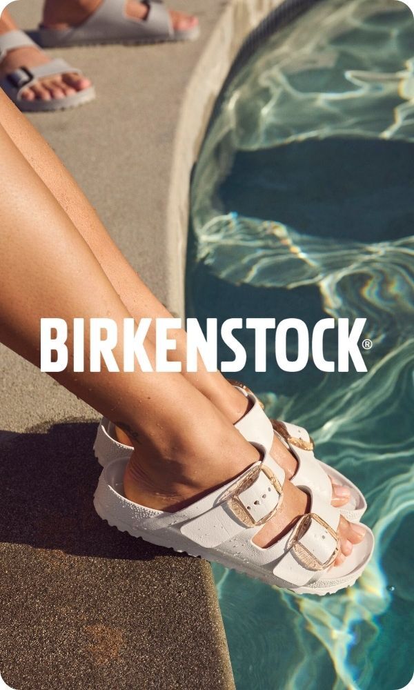 Woman, poolside wearing Birkenstock sandals over the water, logo on top