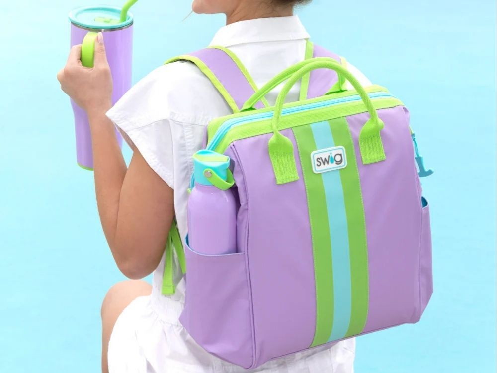 A woman wearing a Swig Life backpack soft cooler