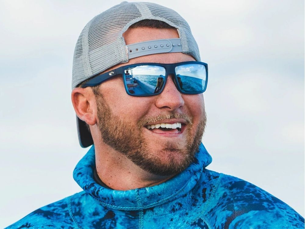 A man fishing wearing Costa sunglasses