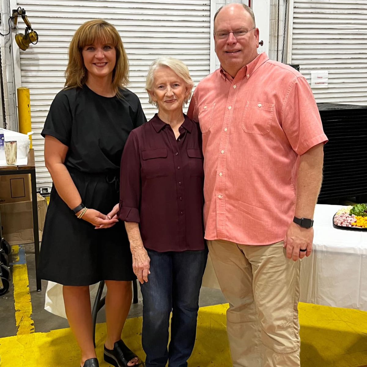 Mark and Susan Anderson standing side by side with Martha in between them