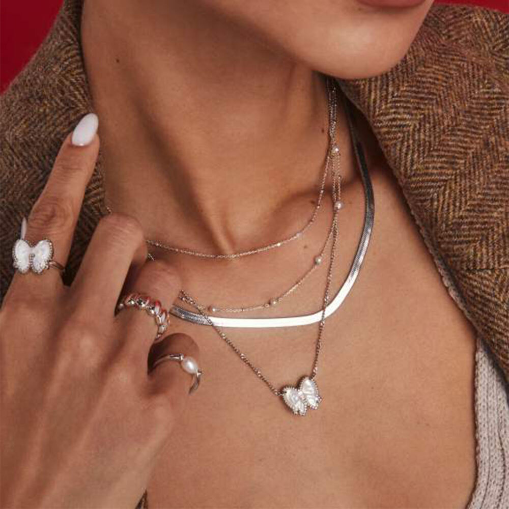 Woman wearing Kendra Scott Haley Bow necklace and ring