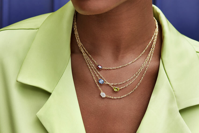 Woman wearing Kendra Scott necklaces