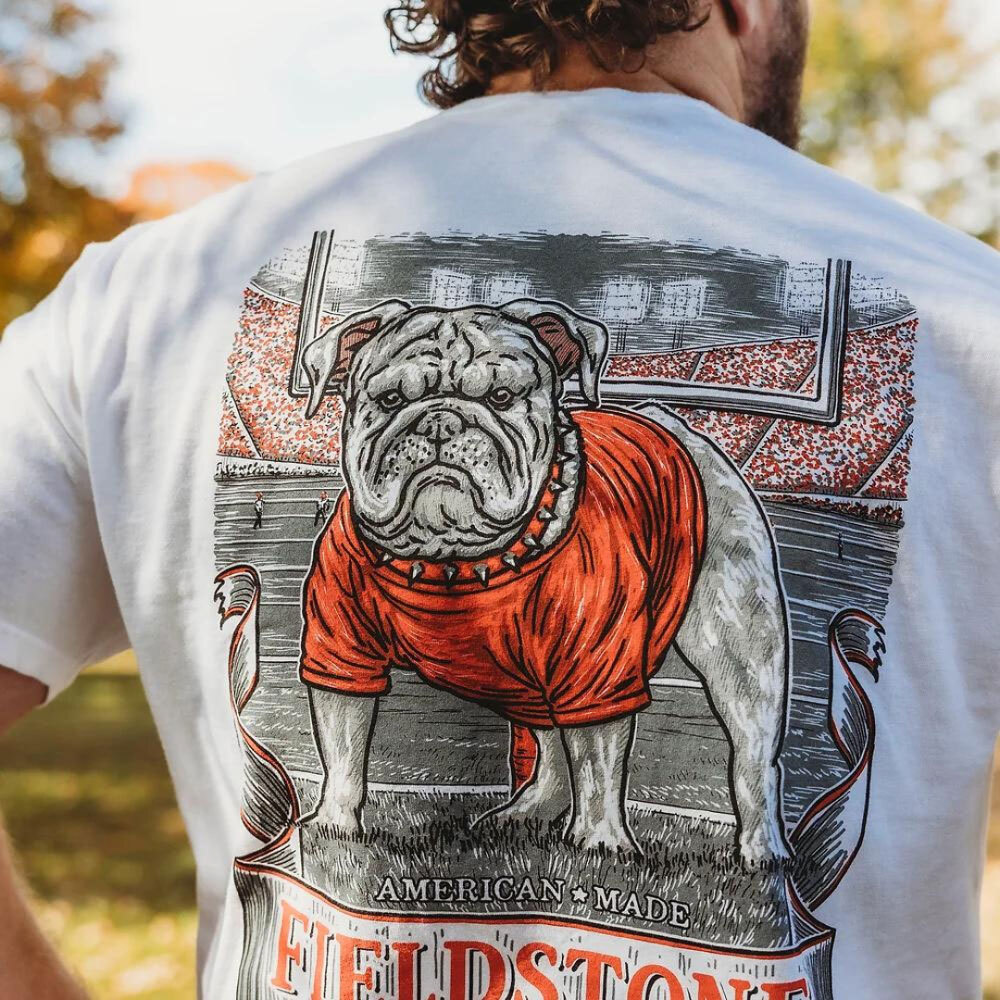 Man wearing a white Fieldstone collegiate tee with the Georgia Bulldog mascot on the graphic