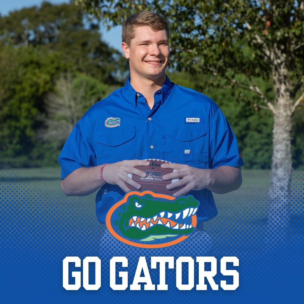 The University of Florida Collegiate Apparel. Man throwing football wearing a blue University of Florida short sleeve button down shirt.