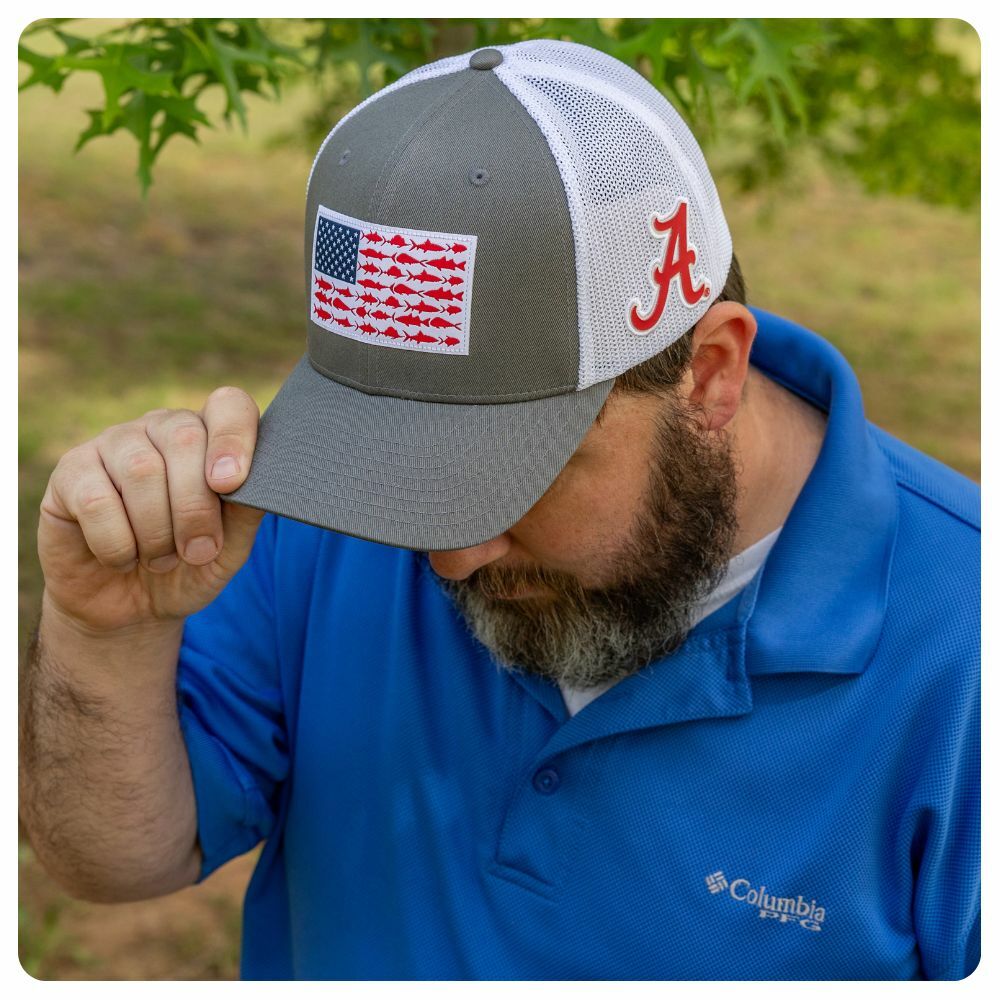 Man wearing a grey and white Columbia Collegiate PFG Fish Flag Hat with Alabama logo