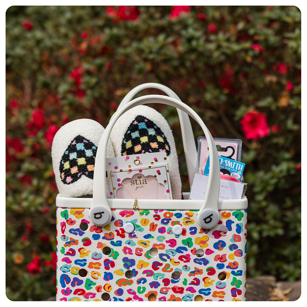 Multi colored Bogg Bag Bitty with Easter basket gifts inside.