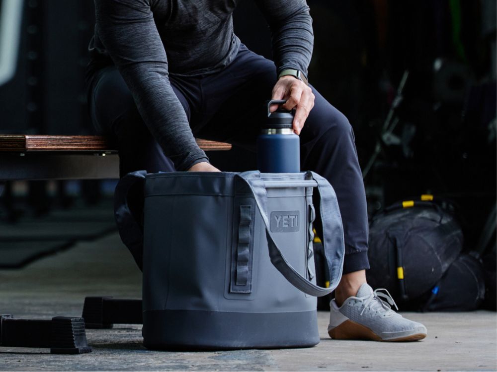 Man organizing a Yeti Carry All Bag