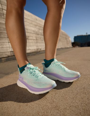 A person wearing Hoka Clifton 9 Sneakers