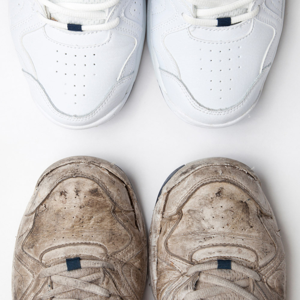 A pair of dirty sneakers next to bright white, clean sneakers