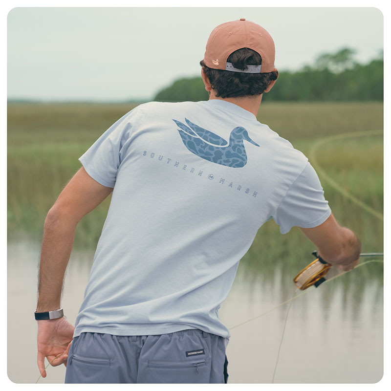 Man fly fishing wearing a Southern Marsh t-shirt