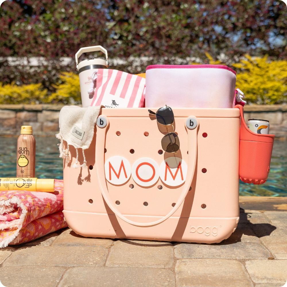 Bogg Bag filled with various items such as a Stanley bottle, Bogg Bevy, Towels and more.