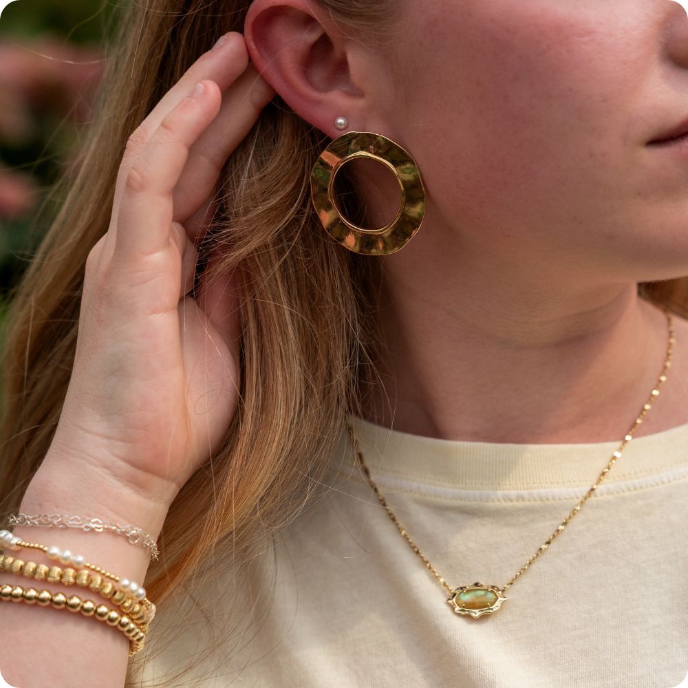 Woman wearing Kendra Scott and Beaded Blondes jewelry