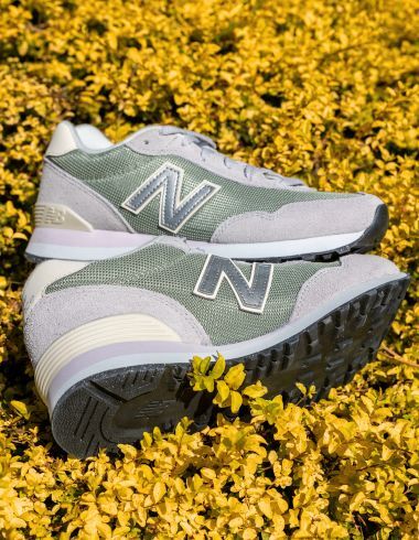 A pair of New Balance shoes in some greenery.