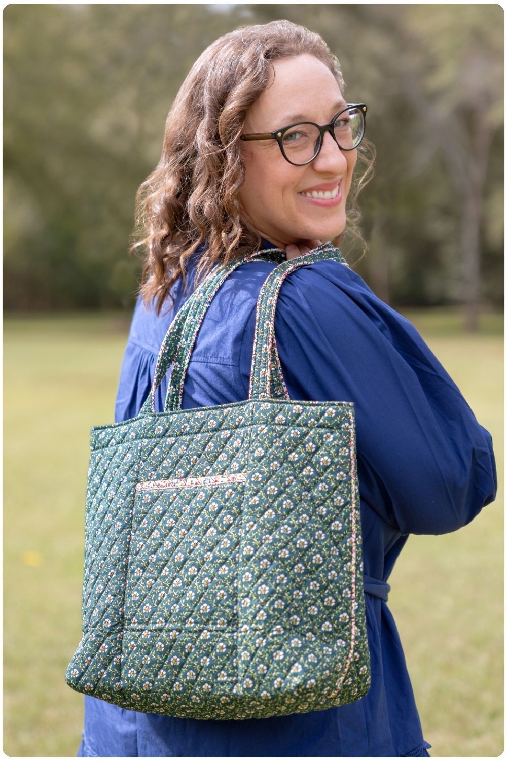 Woman smiling holding a Vera Bradley shoulder tote