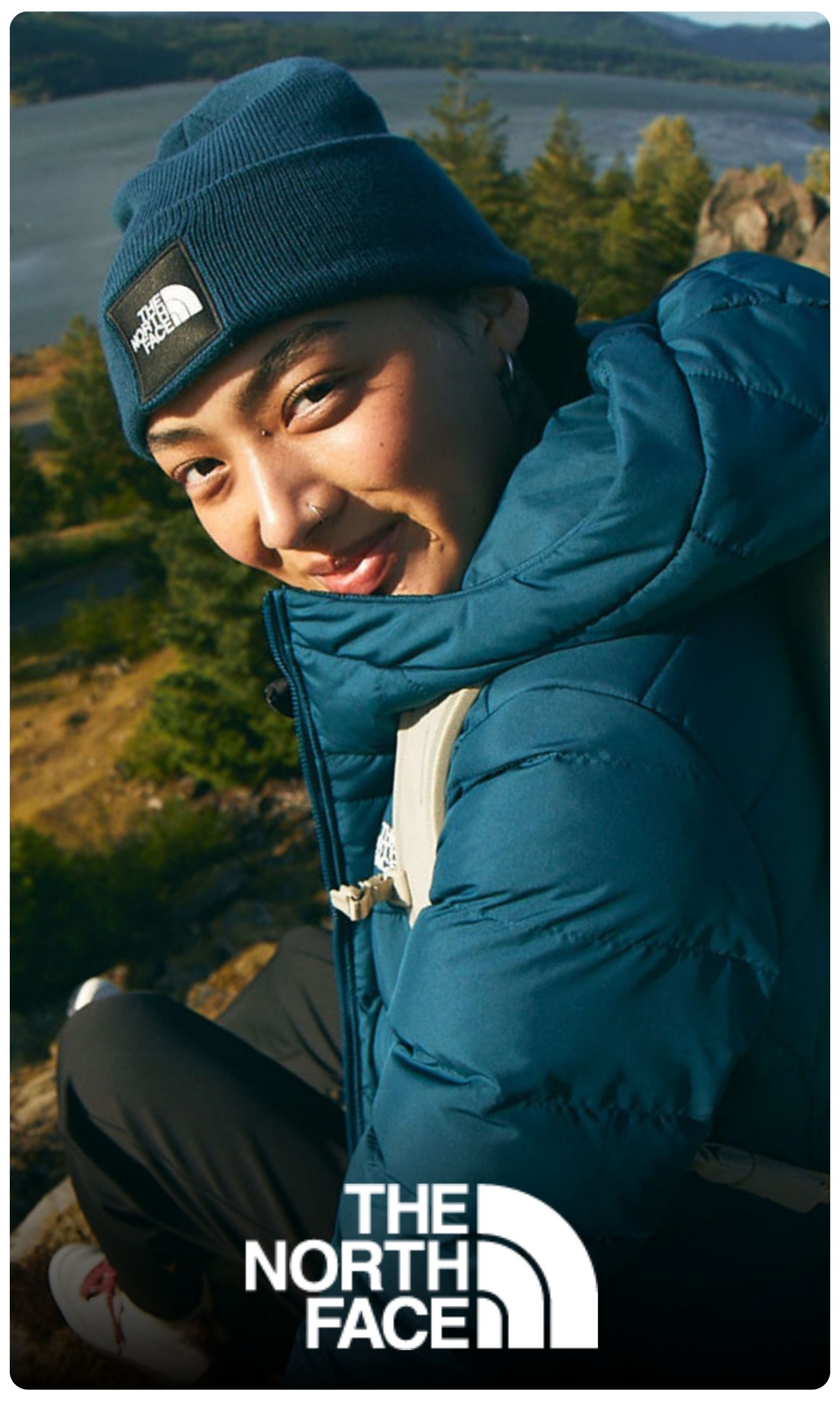 The North Face logo, woman wearing jacket and beanie