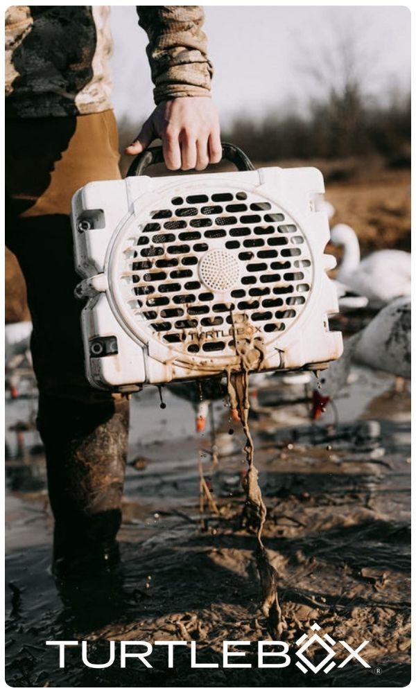 Turtlebox logo, man holding waterproof bluetooth speaker
