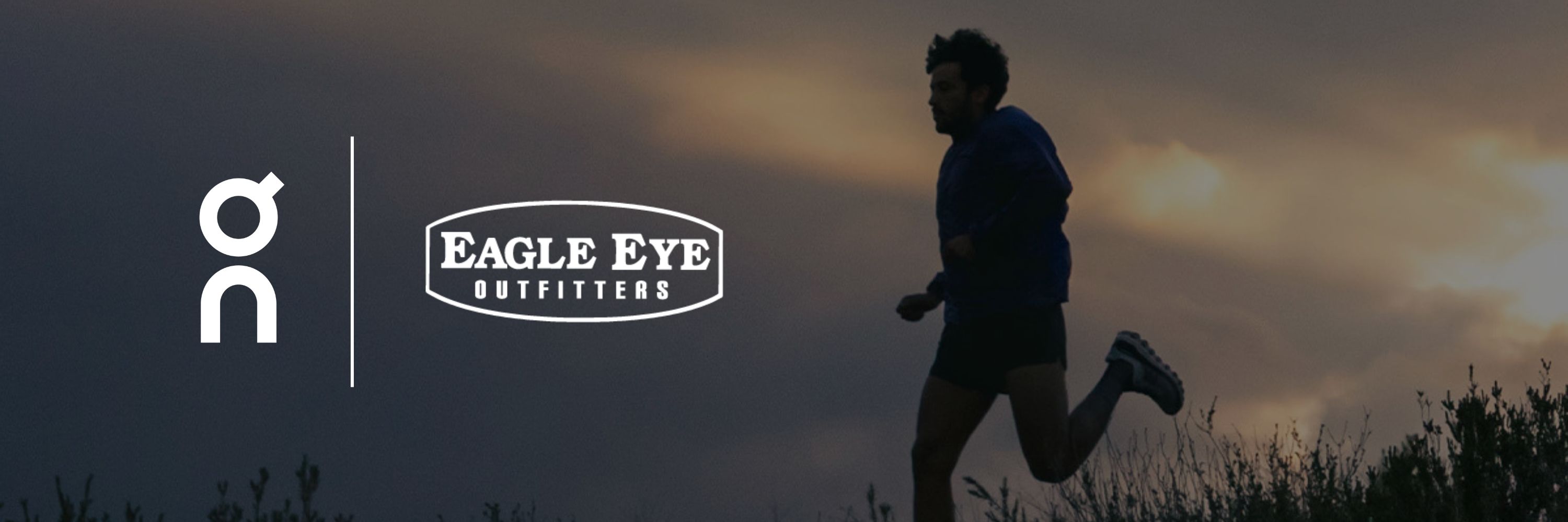 Shadow of a man running in a field at dusk wearing a pair of On Running Shoes. On and Eagle Eye Outfitters logos.