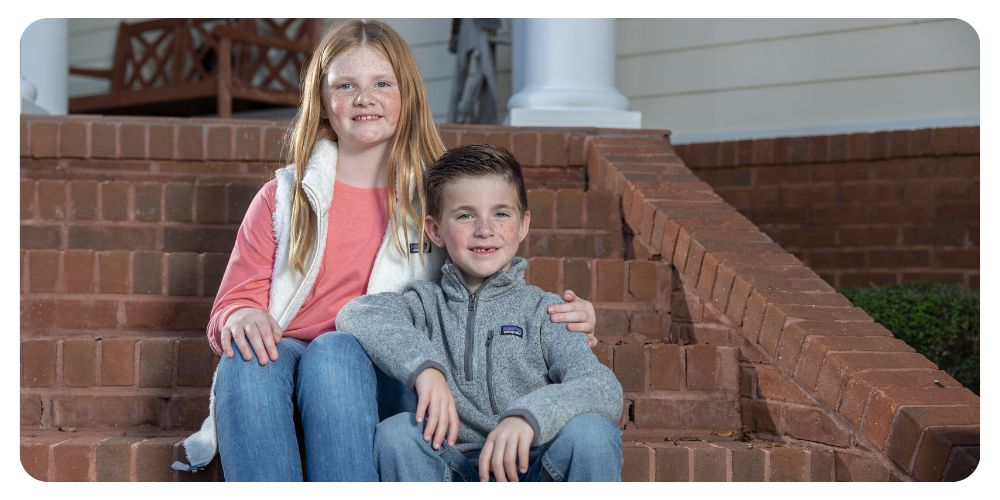 Boy and girl sitting on steps wearing Patagonia apparel