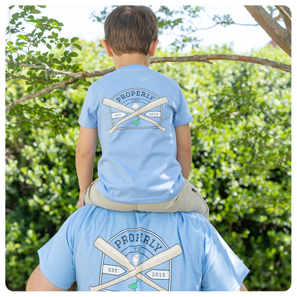 Picture of son on father's shoulders both wearing Properly Tied T-Shirts