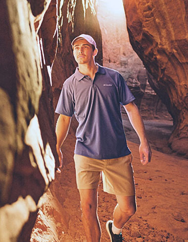 Man walking through a canyon