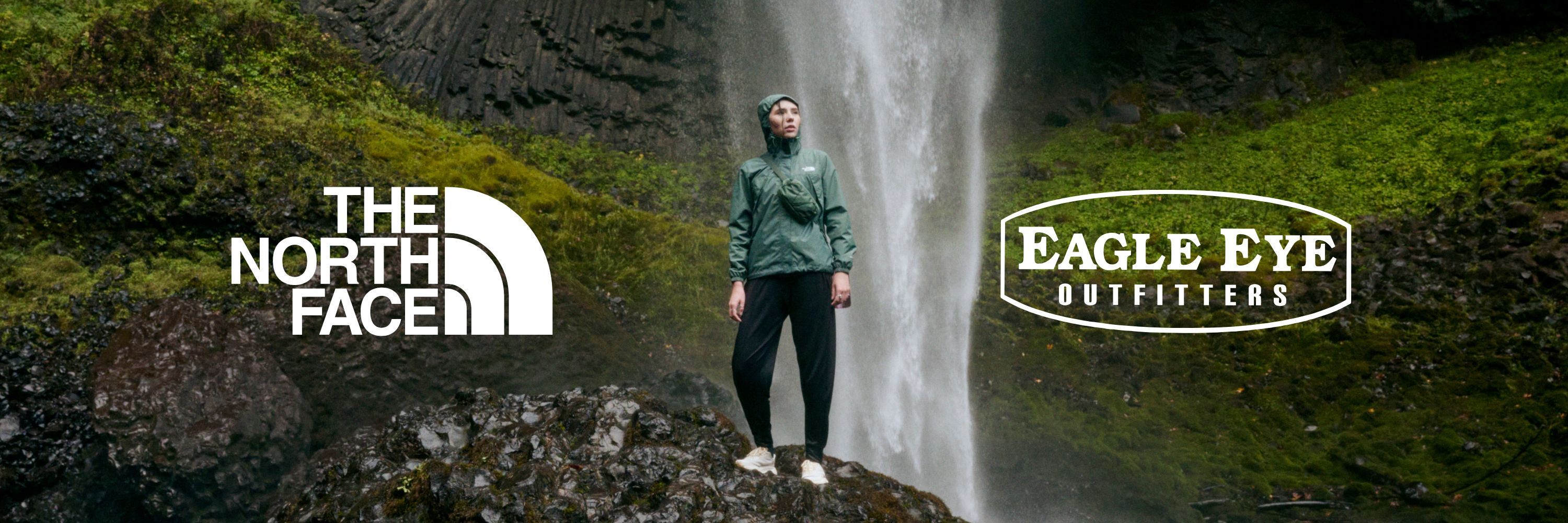 The North Face and Eagle Eye Outfitters logo over a photo of a Woman standing infront of a waterfall wearing The North Face jacket