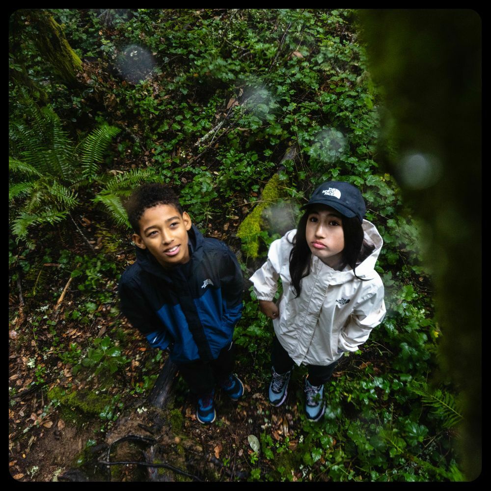 A boy wearing a The North Face hoodie and a girl wearing a The North Face jacket