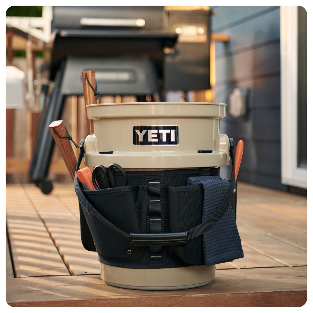 A Yeti Loadout Bucket used for grilling gear on the back porch