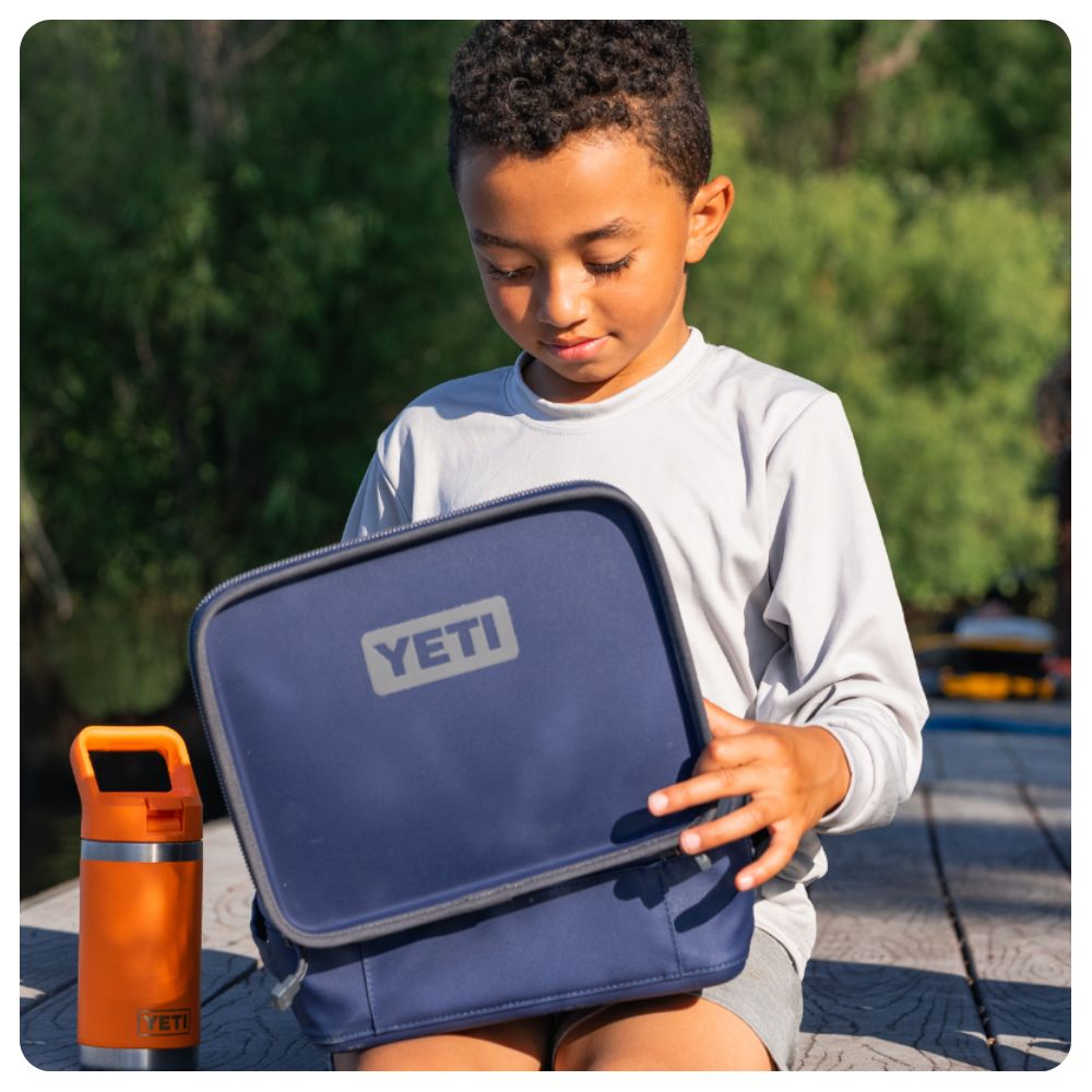 Boy holding a Yeti Lunch Box