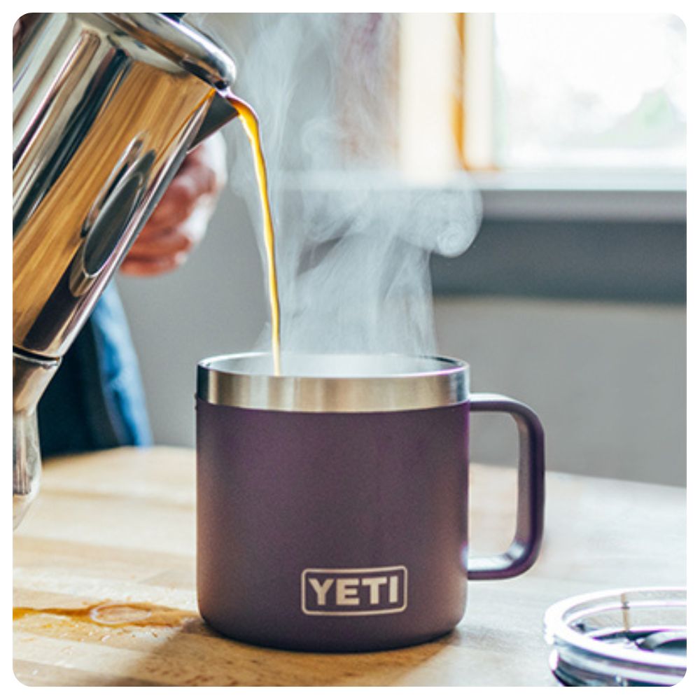 Coffee being poured into an old style of Yeti's Rambler Mug