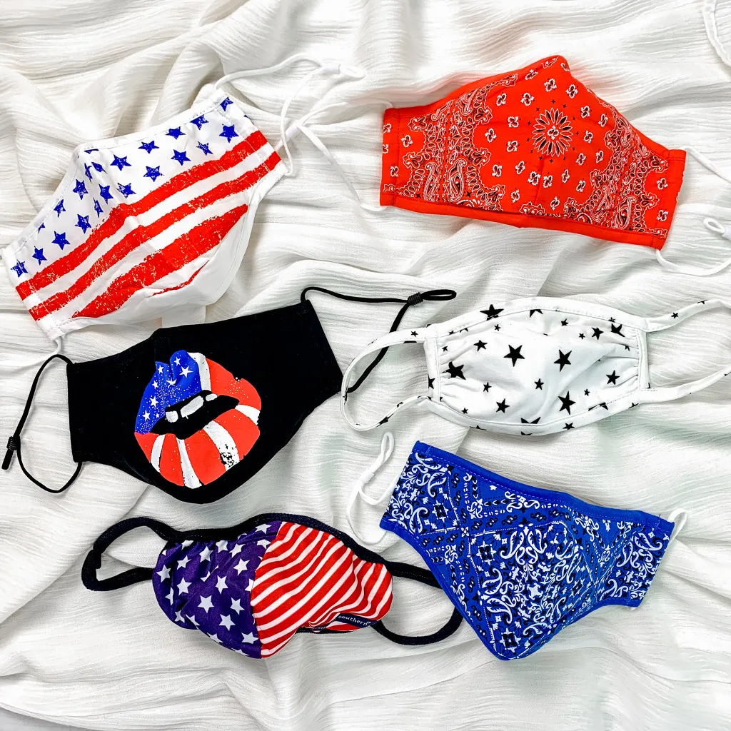 A picture of six red, white, and blue colored face masks some with stars and stripes patterns.