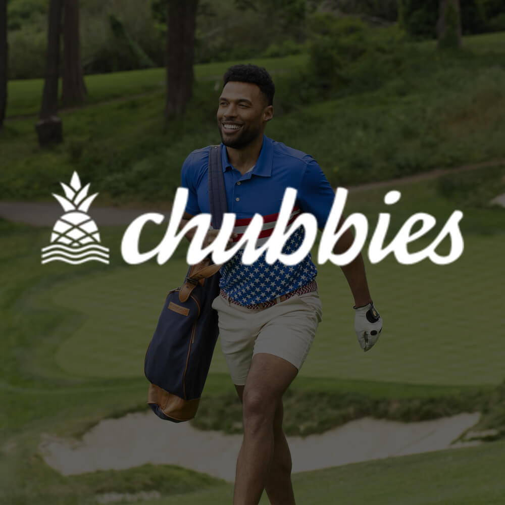 Chubbies logo over a man walking on a golf course carrying his golf clubs wearing a Chubbies polo and khaki shorts.