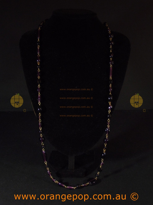 Linked beaded purple tone necklace