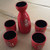 Ceramic japanese sake set, black glaze inside red glaze outside.