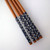 Bamboo chopsticks end decorated with blue cherry blossom.