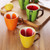 Novelty fruit shaped ceramic cups: yellow lemon, orange orange, red strawberry