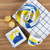 Hand painted ceramic dinnerware features a blue and yellow volleyball pattern
