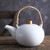 Round white porcelain teapot with bamboo handle