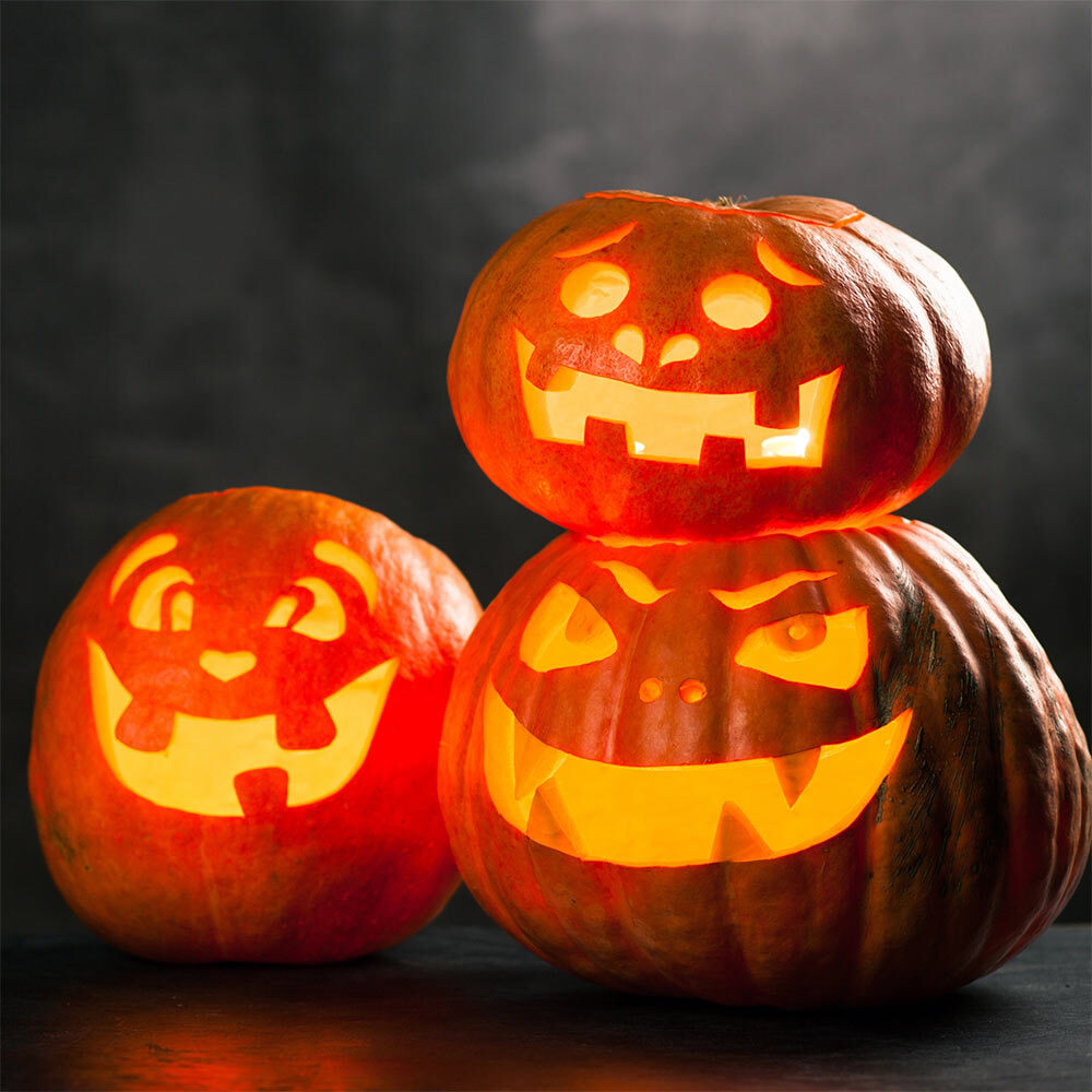 A trio of jack-o'-lanterns featuring unique carved faces, showcasing Halloween spirit and creativity.