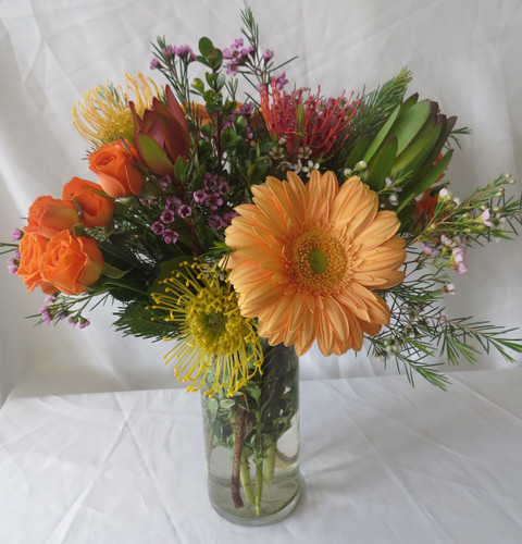 Peaches and Crème Gerbera Rose Bouquet by Enchanted Florist Pasadena TX is a smaller version of our Wild Nectarine Protea and Gerbera Bouquet. 
 This bouquet includes tropical flowers called protea, orange gerbera daisies, orange roses and safari sunset and is accented with various foliages. Arrives in a clear cylinder vase. Approximately 16"W x 14"W  For local delivery only.
SKU RM157  
Hand delivered today by a real florist in Houston TX, Deer Park TX, Webster TX and surrounding areas. 