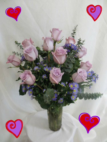 Lovely Lavender Dozen Roses for Valentines Day by Enchanted Florist Pasadena TX - For the purple lover in your life, we bring you a lovely dozen lavender roses complete with purple novi belgi and eucalyptus in a vase. Send a lovely lavender bouquet of roses and delight her senses. RM920