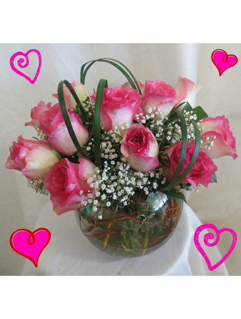 Love Bowl of Pink Roses for Valentine's Day by Enchanted Florist Pasadena TX. One dozen pretty variegated hot pink tipped creme roses designed by our talented design team in this 8" clear glass rose bowl and accented with tropical foliages and baby's breath. RM904