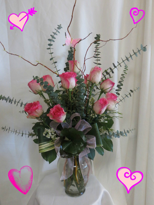 Pink Fire and Ice Premium Dozen Roses by Enchanted Florist in Pasadena TX. Our premium Ecuadorian Malibu roses in an upgraded vase with curly willow, butterfly, and exotic foliages. Malibu is a special bi-colored rose appearing with hot pink tips along creme colored rose petals. Beautiful Valentine roses by the best Deer Park florist. RM906