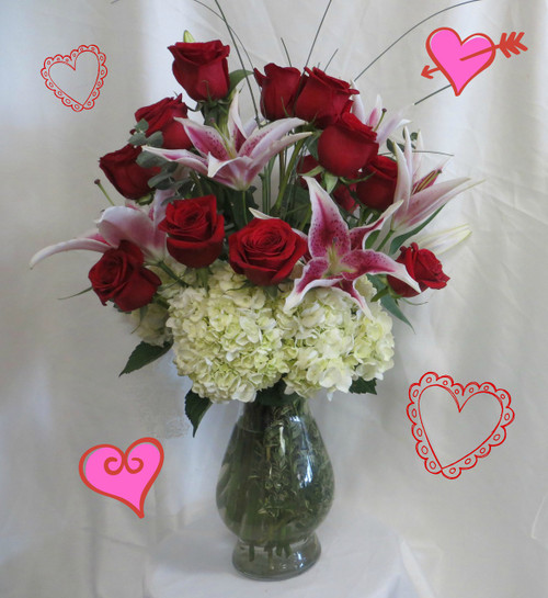 Ultimate Romance Dozen Red Roses for Valentines Day from Enchanted Florist Pasadena TX. It includes our upgraded Bella vase, white hydrangeas, fragrant stargazer lilies, dozen premium red Ecuadorian roses, eucalyptus, and bear grass for the flowy look. RM919