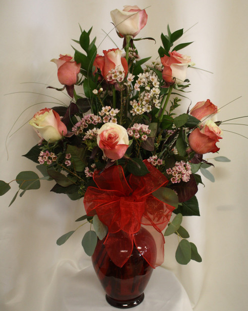 Cupid's Love Premium Dozen Roses by Enchanted Florist Pasadena TX. A premium Rio Ecuadorian rose, this beautiful white flower is hand dyed in red and pink giving it a truly unique look. A perfect choice for your unique Valentine's. RM960