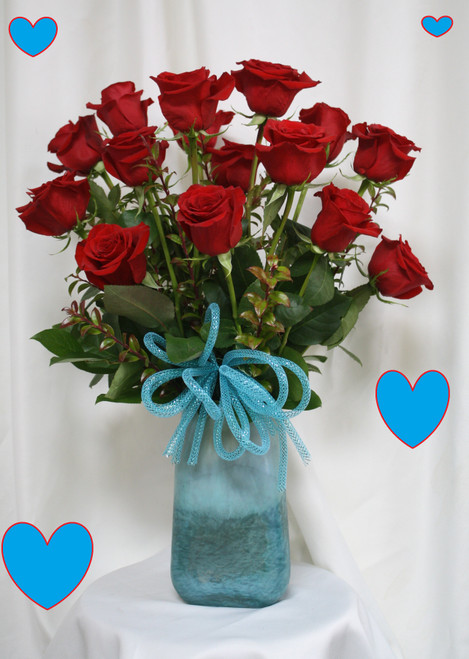 Love Song Red Roses with Turquoise Vase for Valentines Day by Enchanted Florist Pasadena TX. Sing out your love to your sweetheart this Valentine's Day with romantic red roses expertly designed in this keepsake turquoise vase. 
Size is approximately 24" H x 16" W   RM965