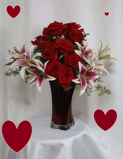 Heart and Soul Red Roses and Stargazers for Valentines Day by Enchanted Florist TX. Our two most popular flower requests teamed up together to make this stunning and romantic display of love and affection for your Valentine. The red roses are designed in an abstract heart shape with the stargazer lilies tucked into each side and accented with seeded eucalyptus.
Size is approximately 19"H x 13"W   RM963