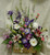 Spring Garden Funeral Basket by Enchanted Florist - This lovely spring garden basket for a funeral is full of spring flowers and is appropriate for the sympathy service or family home. Spring time flowers include iris, white gerbera daisies, stargazer lilies, lavender larkspur, baby's breath and more to complete a cheerful basket of flowers. Approximately 24" W x 30" H
SKU RM503